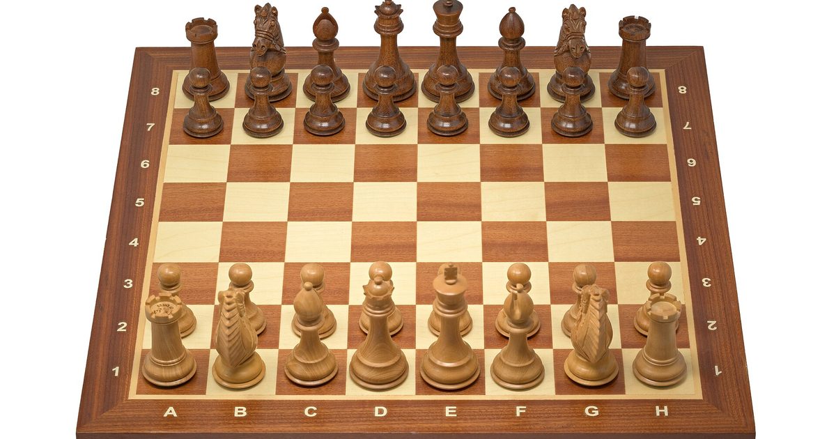 Chess board with two opposing sides set up for a match