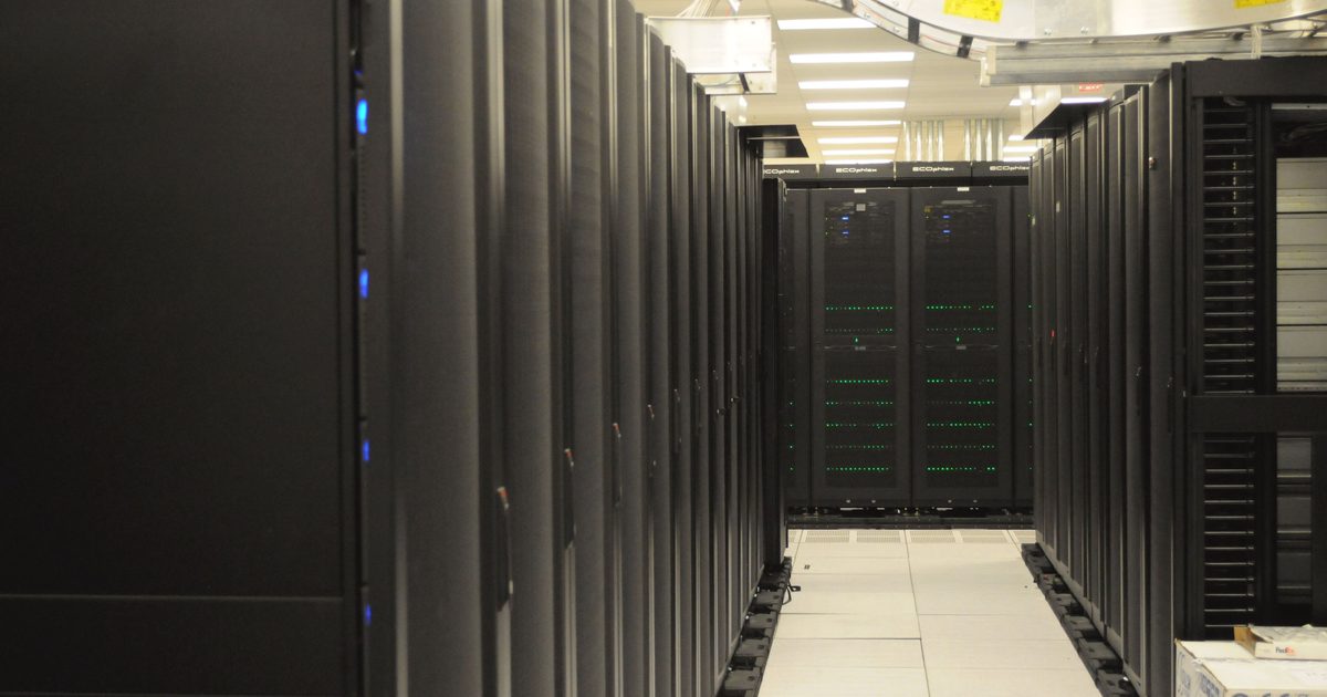 Aisle between rows of server racks in a data center