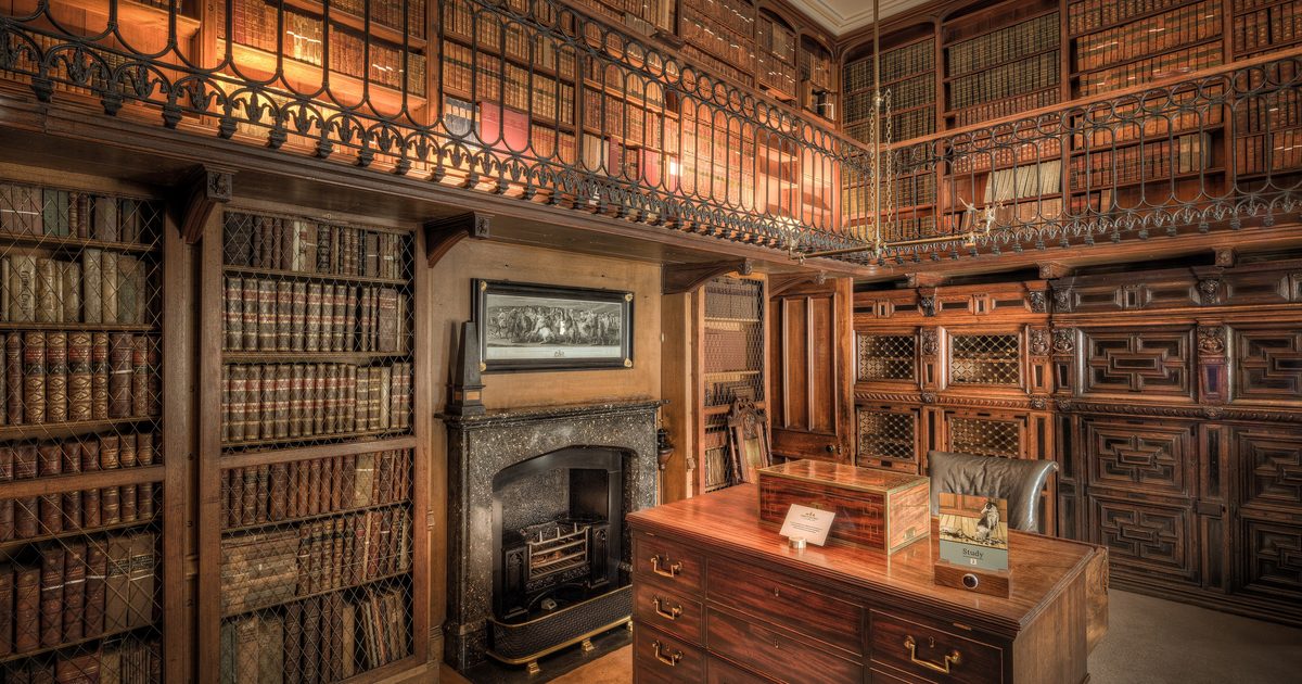Warm library study with floor-to-ceiling organized bookshelves